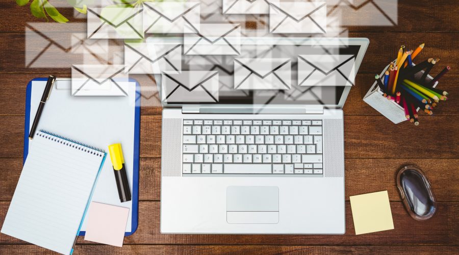 composite image of high angle view of business desk with letter icons
